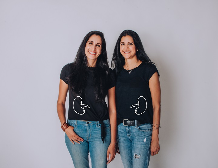 Two smiling women in t-shirts with kidney graphics
