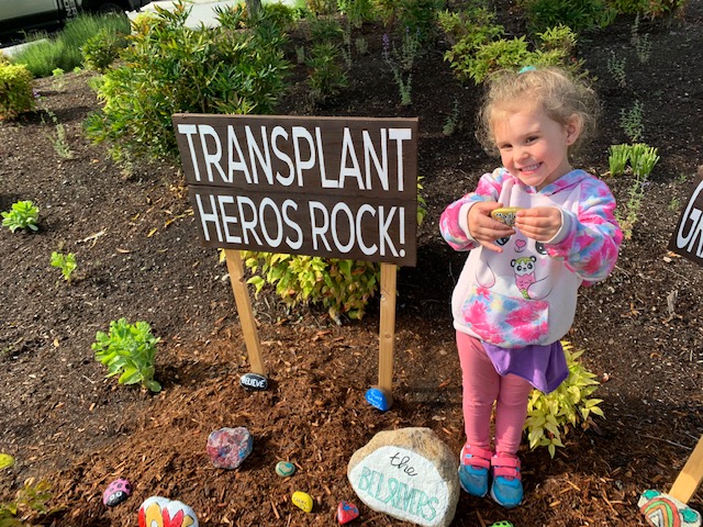 Krista's daughter with her hero rock in memory of her auntie Madeline.jpg